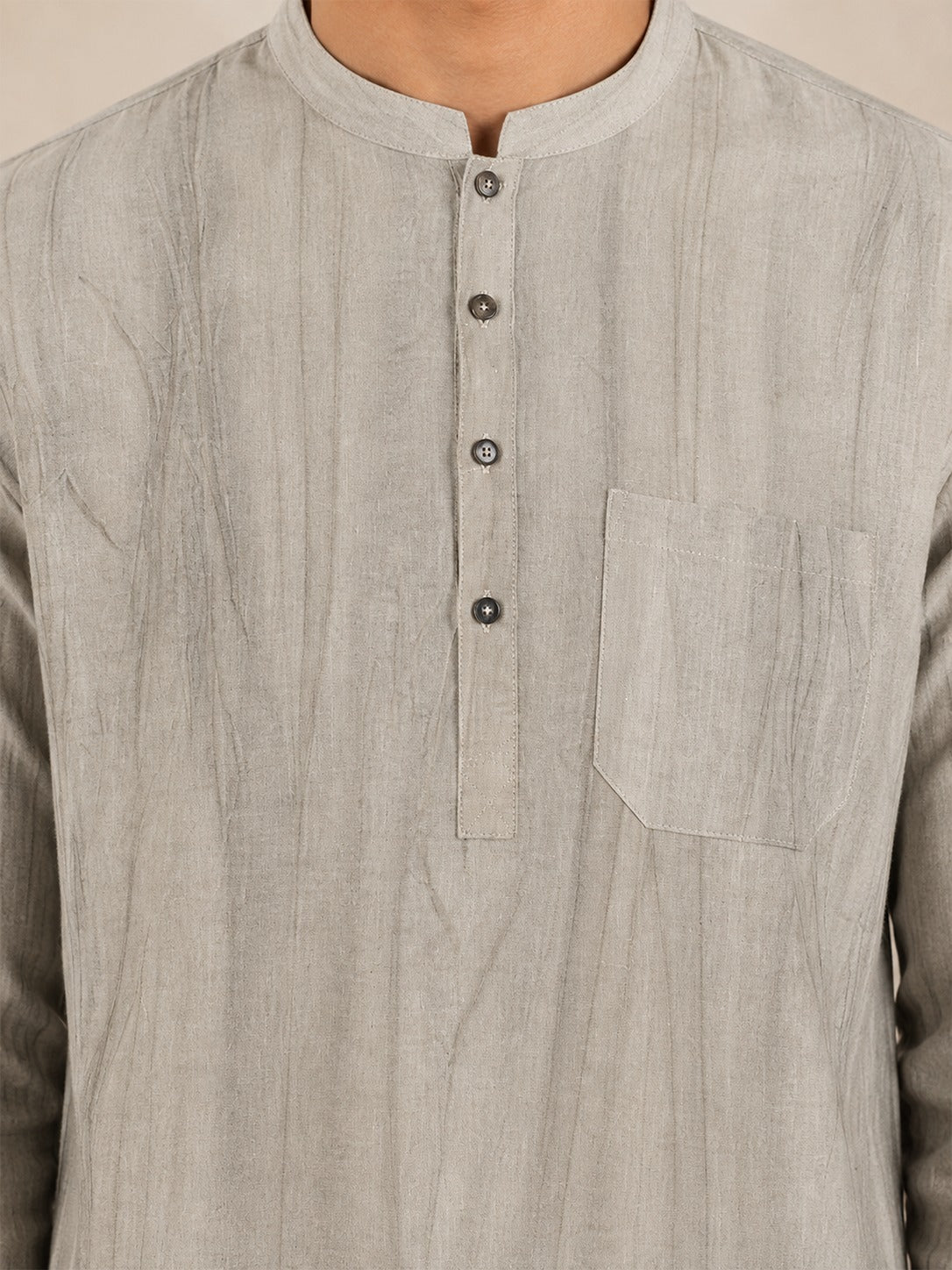 Close-up of the collar, placket, buttons and chest pocket on the beige smoked linen Pathani
