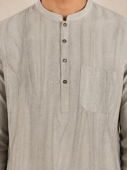 Close-up of the collar, placket, buttons and chest pocket on the beige smoked linen Pathani