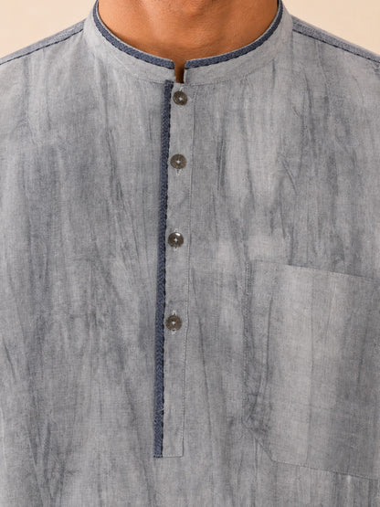 Close-up of the dark blue-grey collar, placket, metallic buttons and chest pocket on the grey smoked linen Pathani