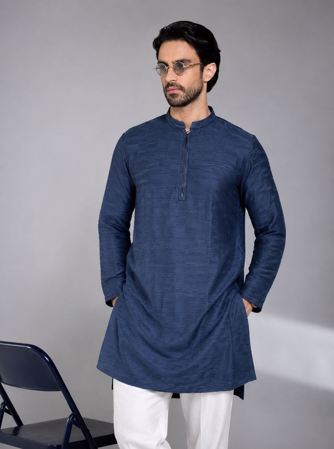 Man in a navy blue textured kurta with white pyjama